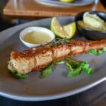 The Rock Pan-fried crayfish tail with lemon, hollandaise and mashed potato on a grey plate, The Rock
