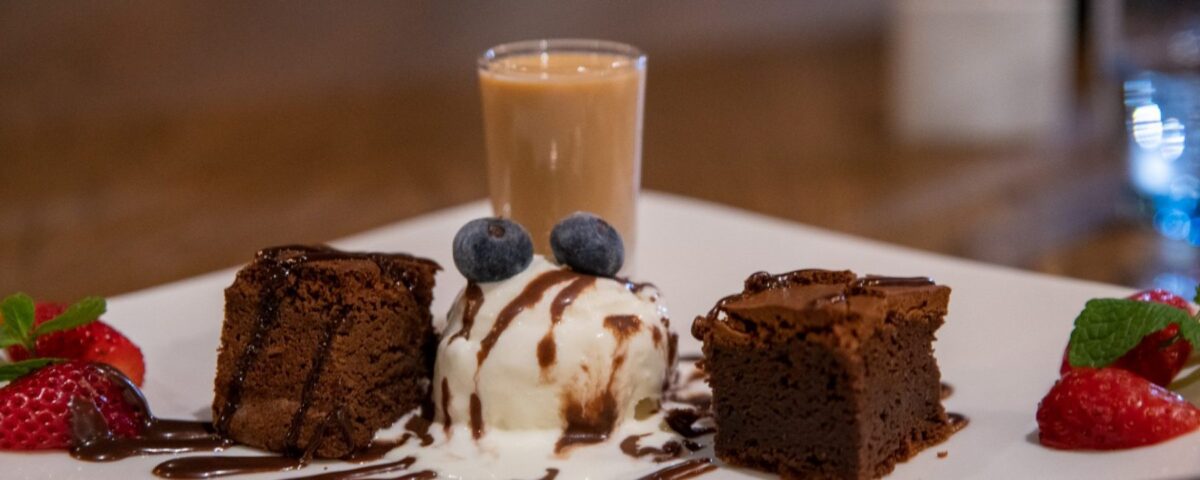 a white plate topped with cake and ice cream.