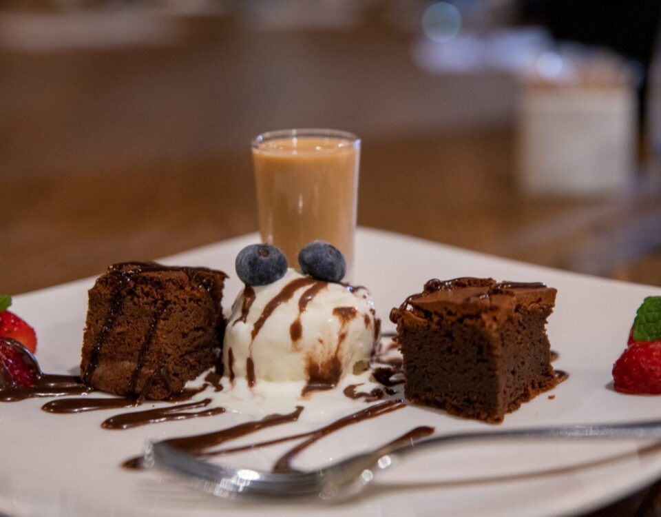 Wickleys Steakhouse a white plate topped with cake and ice cream.