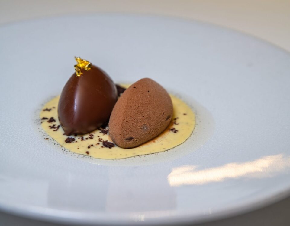 Two pieces of Rijks chocolate on a white plate.