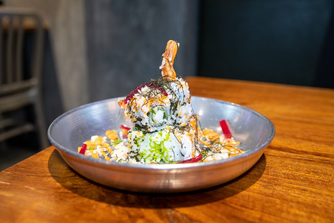 A Plate Of Food On A Wooden Table At 3 Fils Dubai.