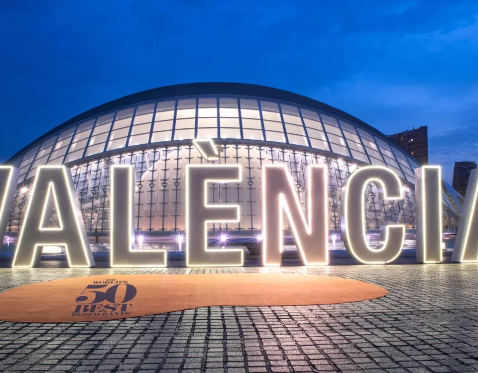 The word valencia is lit up in front of a building.