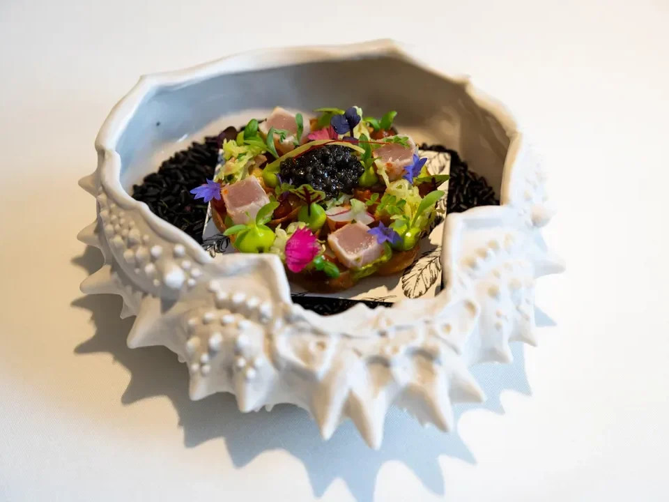 2023 - A white bowl with a fish in it.