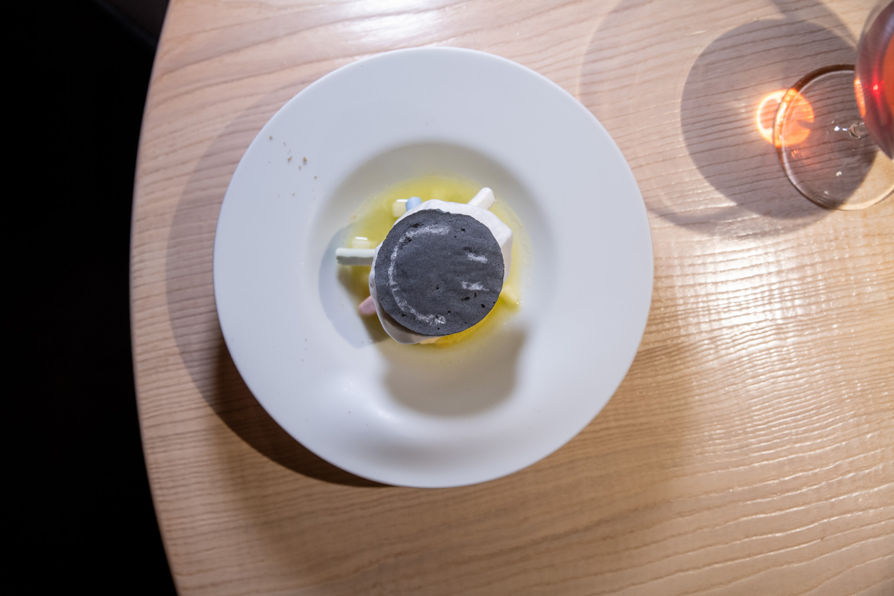 Hand-blown glassware on wood-sculpted tables at Le Calandre, Padua
