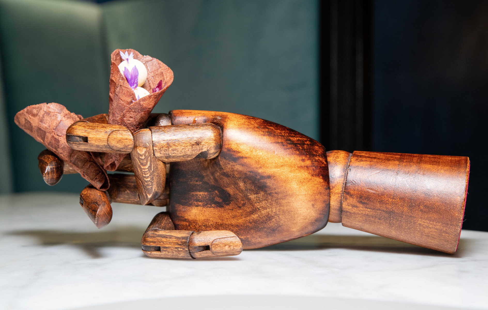 Epoka restaurant dish served on a decorative wooden hand